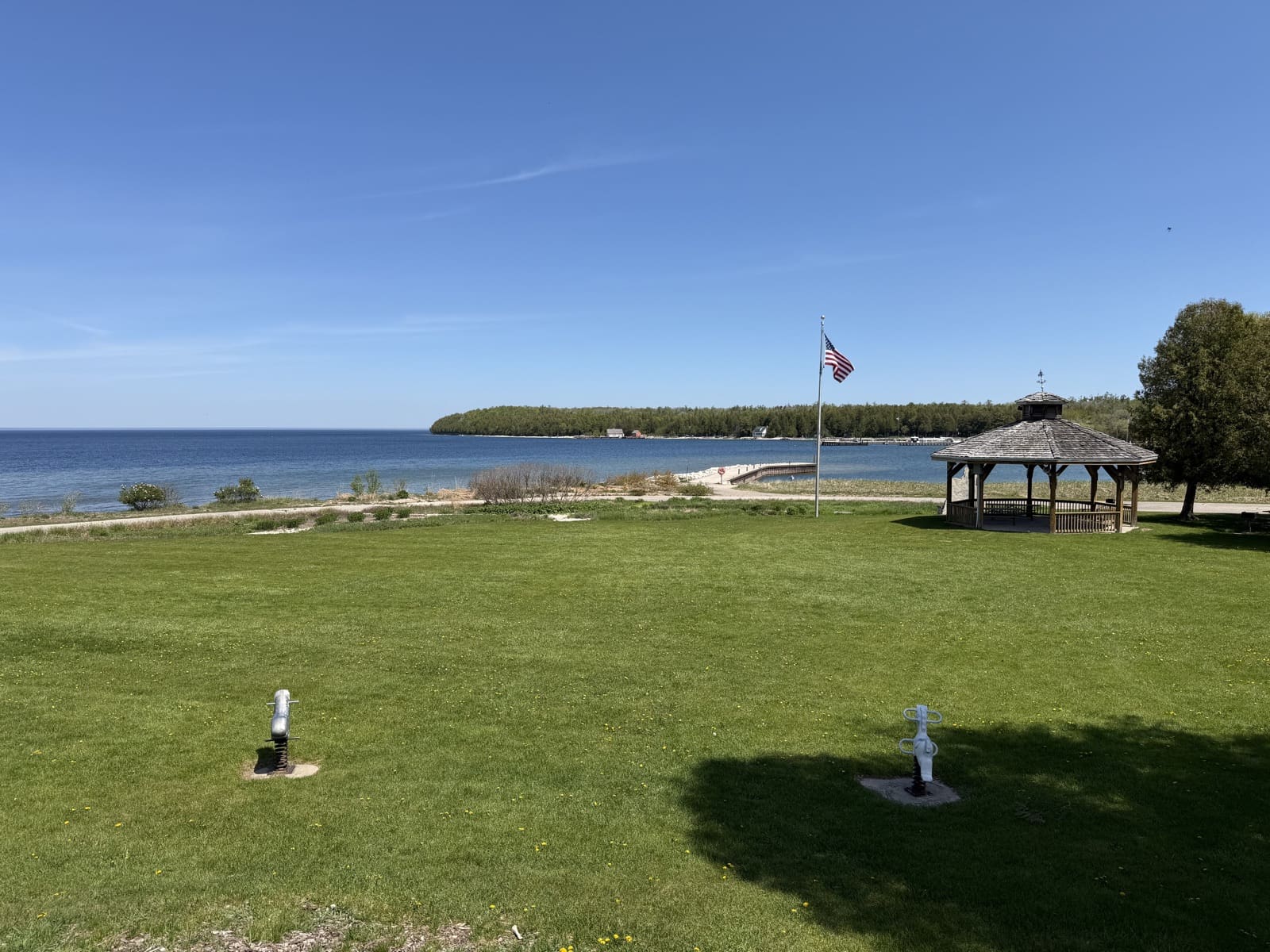 The lawn of Ellison Bay Town Park running down to the sand beach on Green Bay
