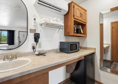 Kitchenette in a Two Queen Room with microwave, mini-fridge, coffee maker and vanity sink